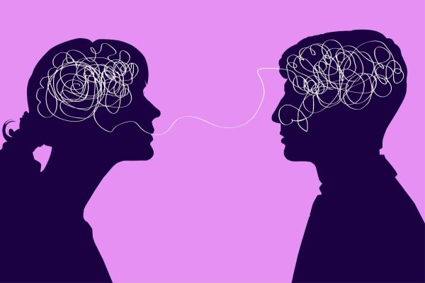 Dialogue between two people, confused thought concept. Communication between a man and a woman, problems in understanding. Two silhouettes with a tangled brain on a pink background